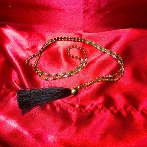 Long tassel and crystal necklace.